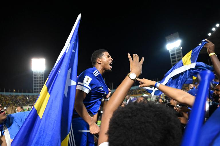 Cura&Atilde;&sect;ao players and fans celebrate World Cup 2026 qualification after a 0-0 draw with Jamaica at the National Stadium in Kingston, Jamaica on November 18, 2025. The tiny Caribbean nation of Curacao became the smallest country ever to qualify for the World Cup on November 18 as Haiti booked their return to the tournament for the first time in 52 years along with Panama.
A nerve-shredding finale to the CONCACAF qualifying campaign saw Curacao -- with a population of just 156,000 -- squeeze into next year's finals in the United States, Canada and Mexico with a 0-0 draw against Jamaica in Kingston. (Photo by Ricardo MAKYN / AFP) (Photo by RICARDO MAKYN/AFP via Getty Images)          